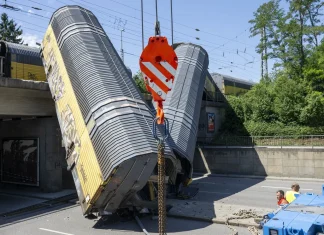 Freight Train Cars Derail Off Bridge, Leaving One Person Dead One dead as freight train wagons plunge off bridge