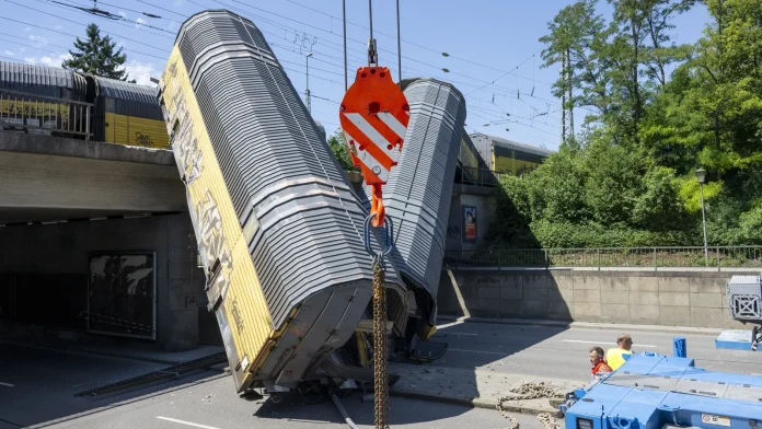 One dead as freight train wagons plunge off bridge