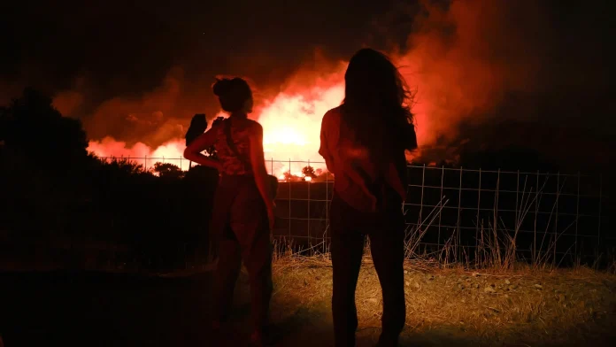 Crete wildfire continues as strong winds hinder firefighting efforts Wildfire rages on Crete as winds hamper firefighting